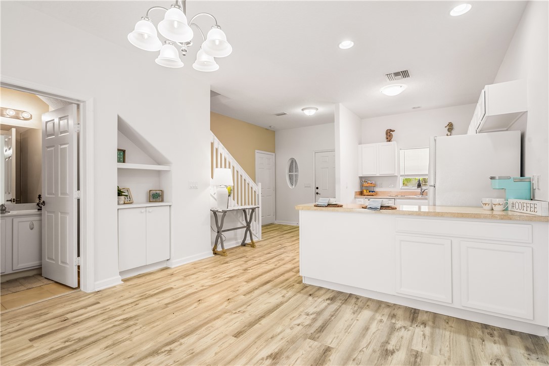 a view of kitchen with cabinets and wooden floor