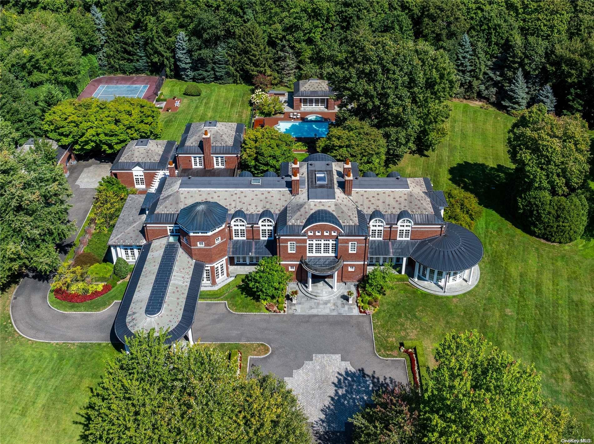 an aerial view of a house with garden space and lake view