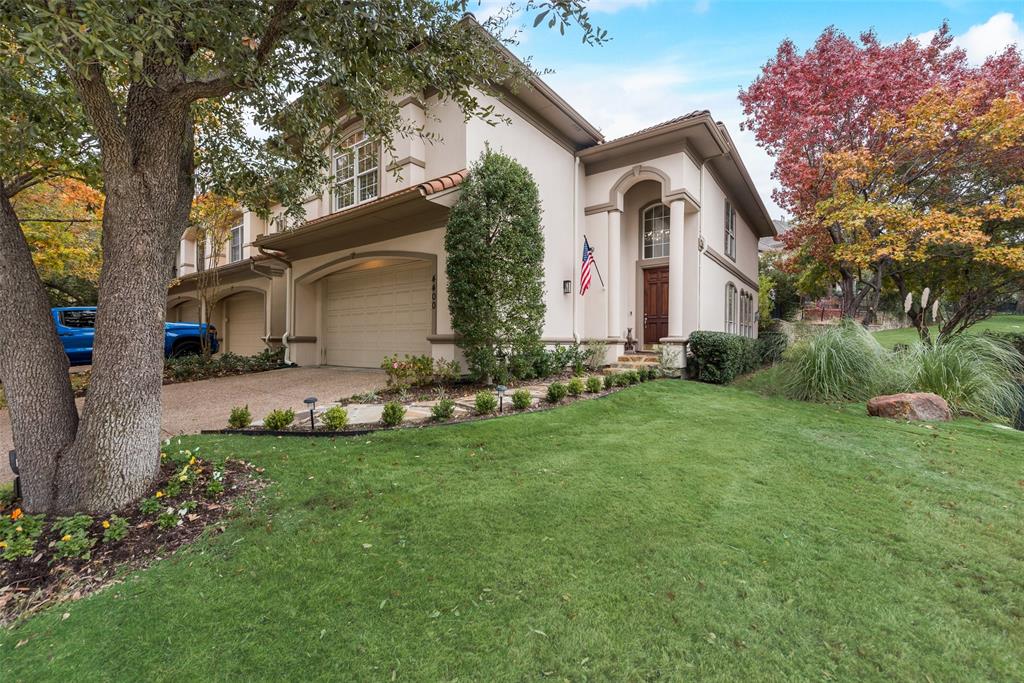 a front view of a house with a garden and plants