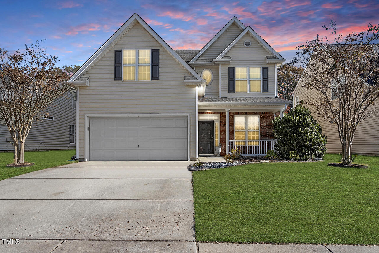 a front view of a house with a yard and garage