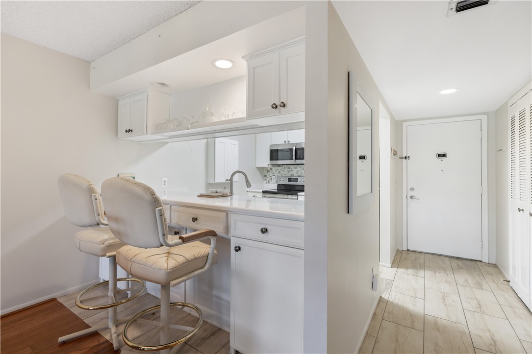 a kitchen with a sink cabinets and wooden floor