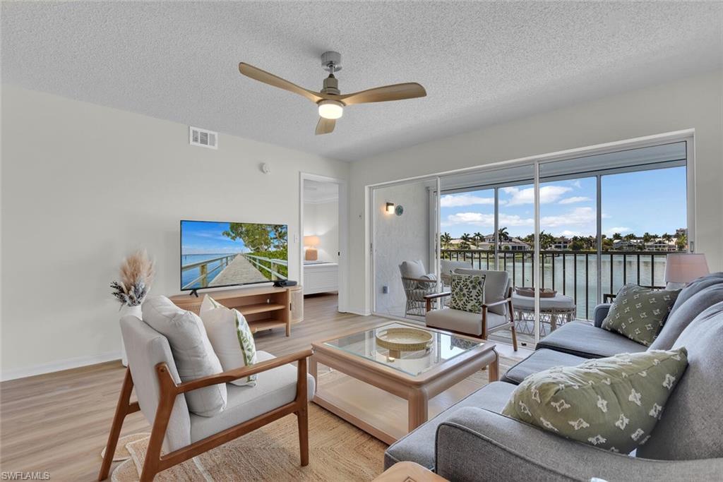 a living room with furniture and a floor to ceiling window