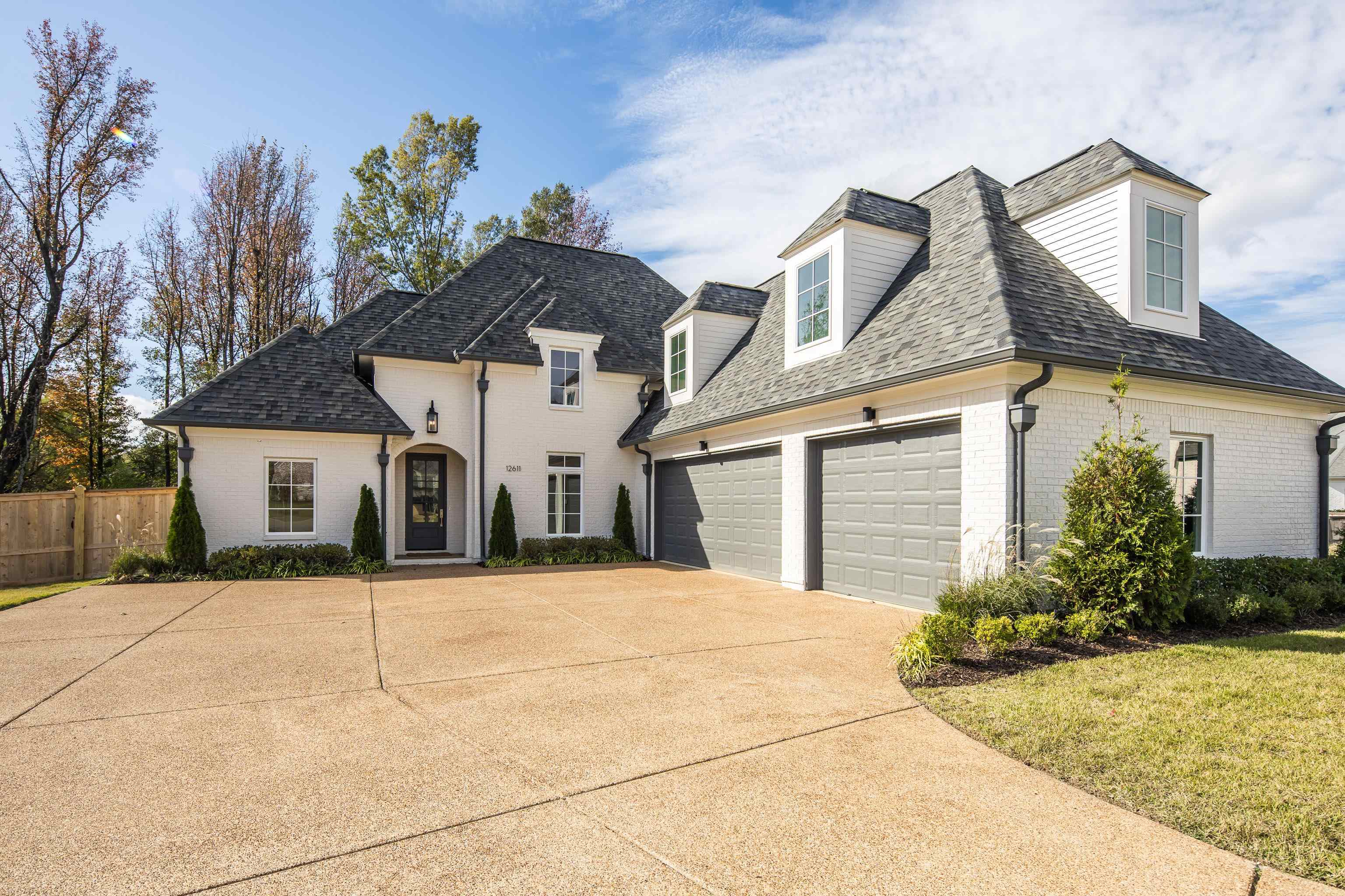 View of front of property with a front yard and a garage