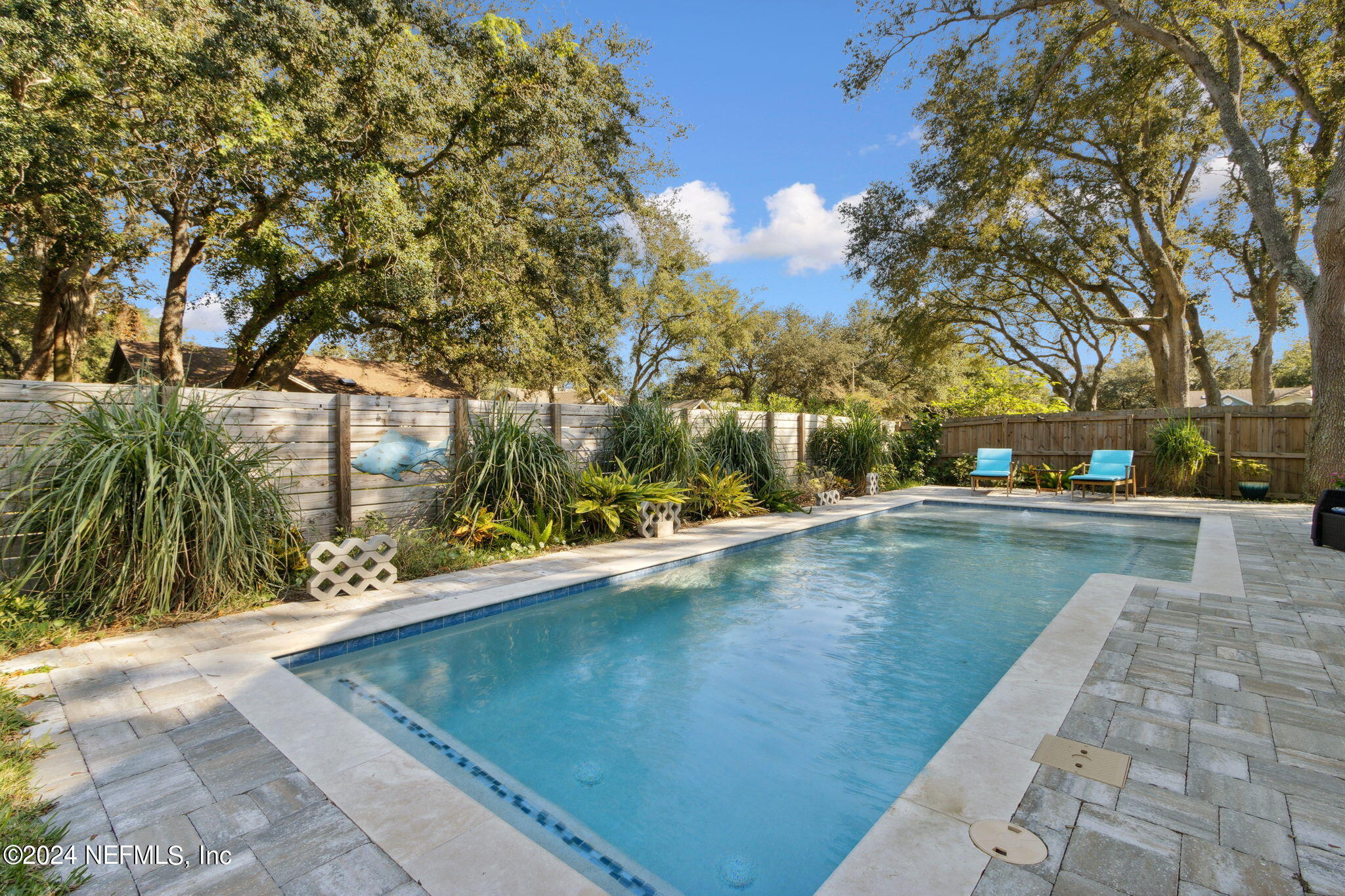 a view of swimming pool with outdoor seating and plants