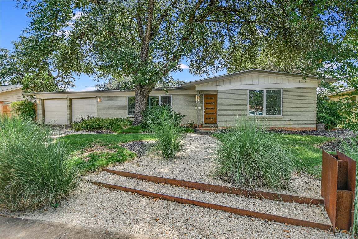 a front view of house with yard and trees