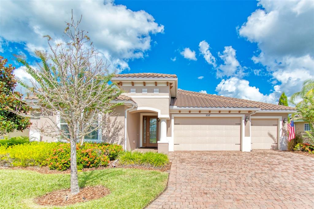 a front view of a house with a yard and garage