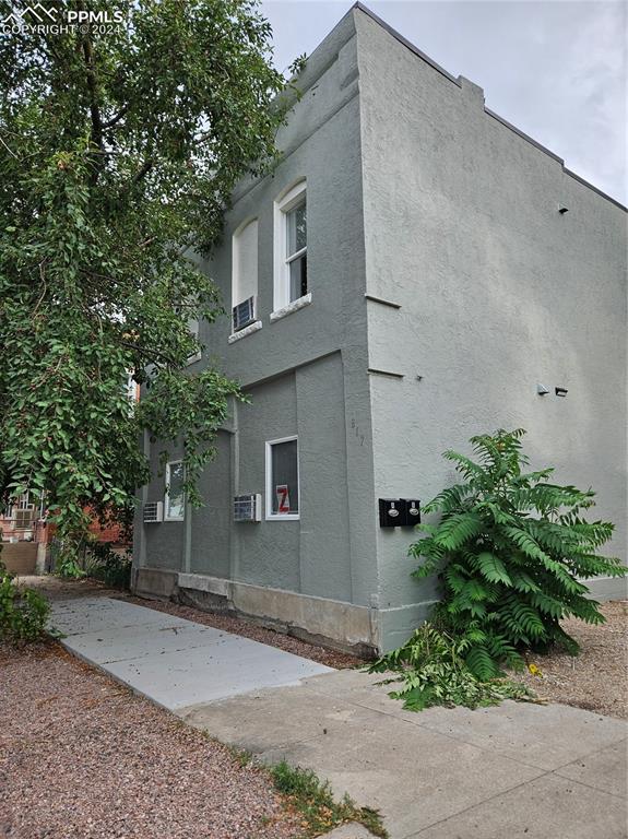 a house that has a tree in front of it