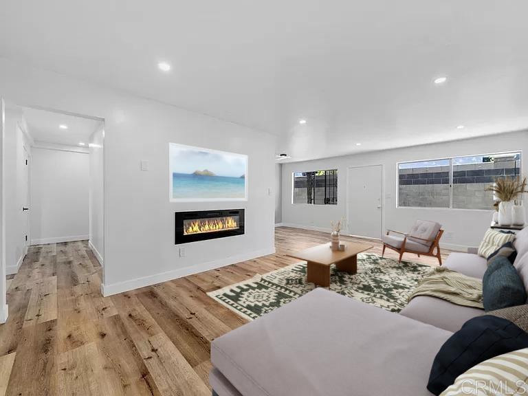 a living room with couches and a coffee table with wooden floor