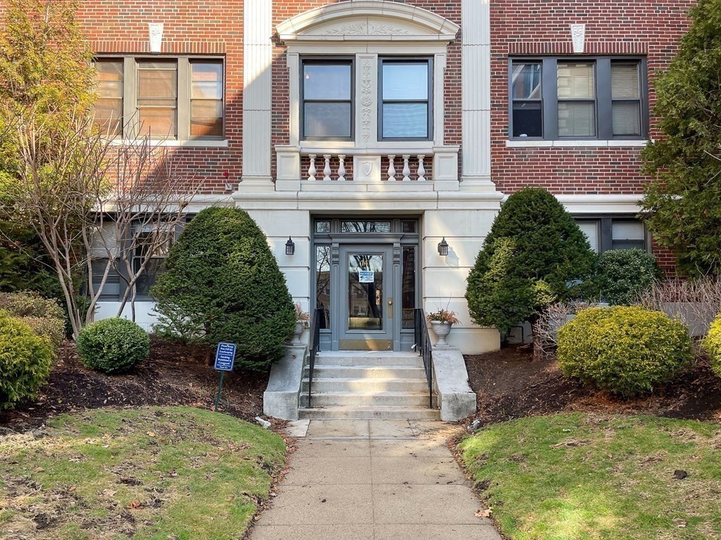 a front view of a house with garden