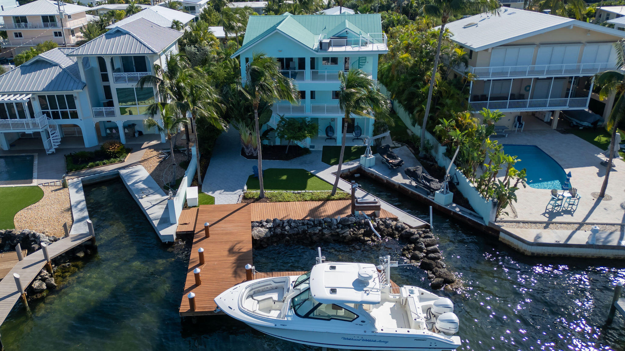 an aerial view of a house with yard swimming pool and outdoor seating