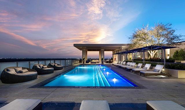 Rooftop pool with sunbeds and poolside cabanas