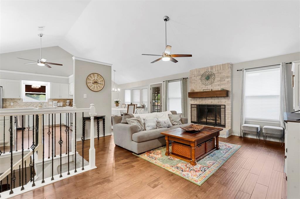 a living room with furniture a fireplace and a window