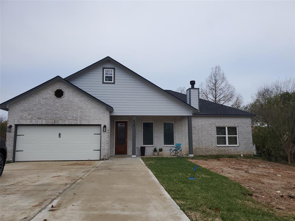 a view of a house with a yard and garage