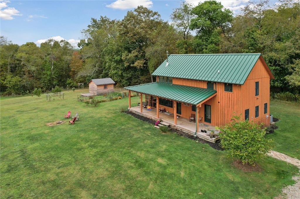 an aerial view of a house with a big yard