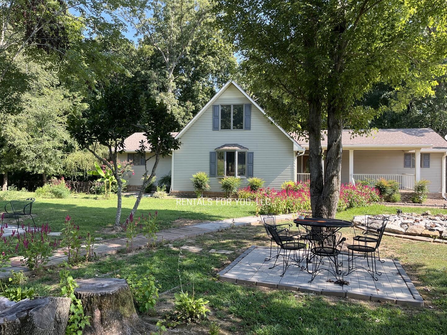 a front view of house with a garden and patio