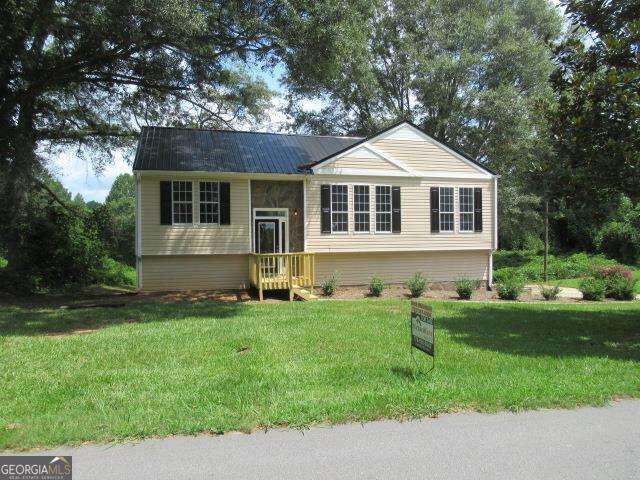 a front view of a house with a yard