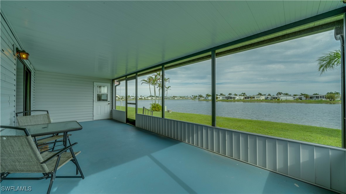 a view of a porch with furniture and floor to ceiling window