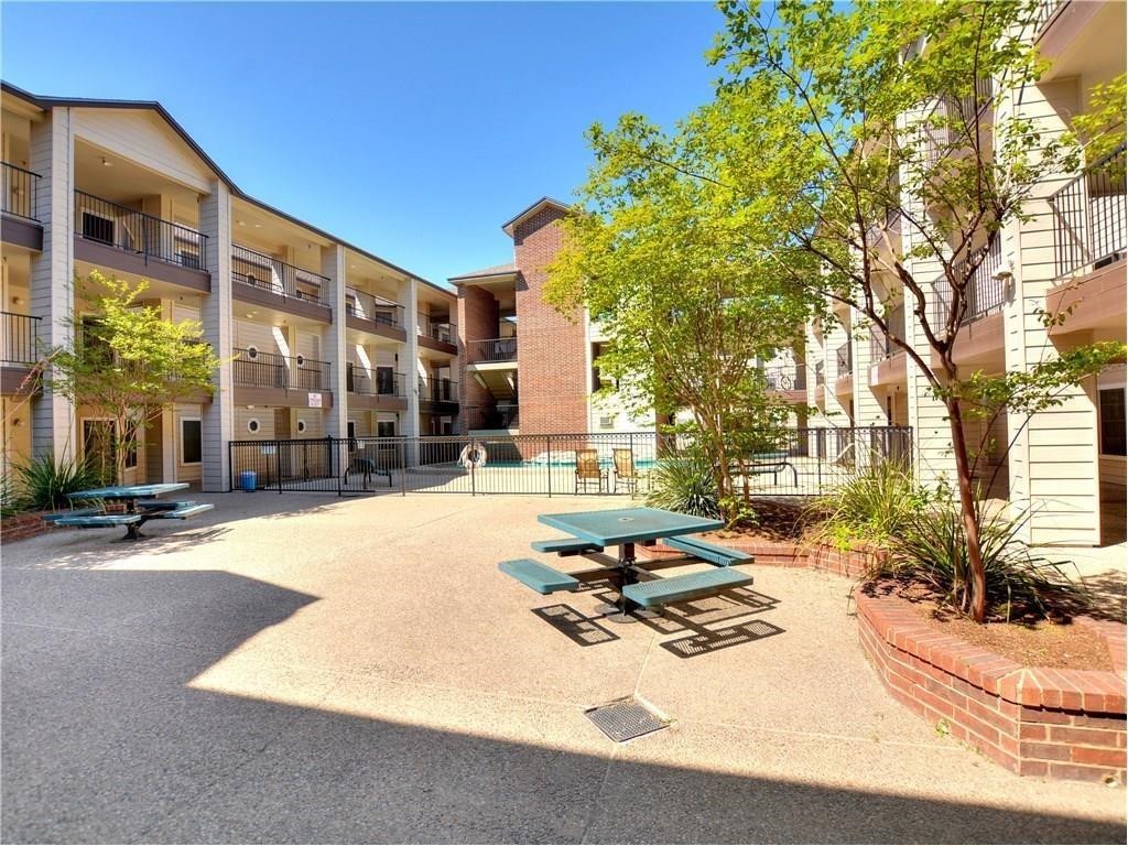 a swimming pool with outdoor seating and yard