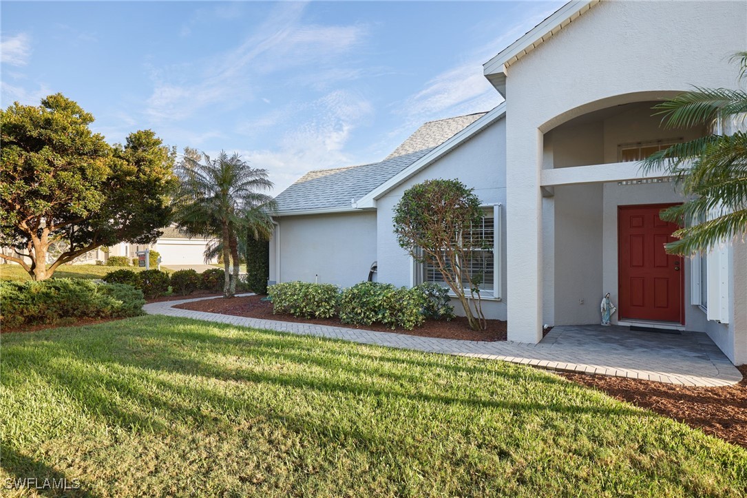 a view of a house with a yard and garage