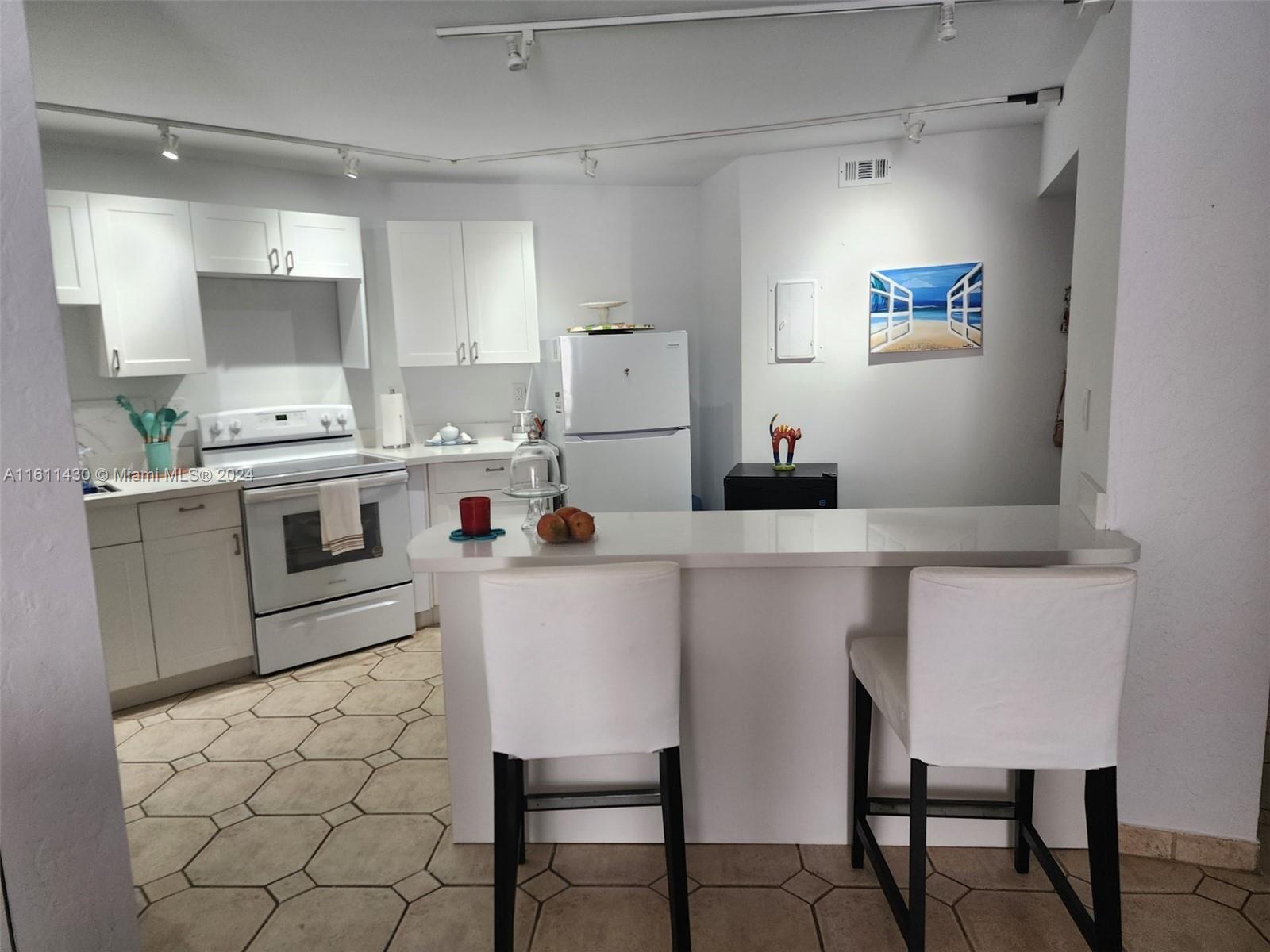 a kitchen with a dining table cabinets and appliances