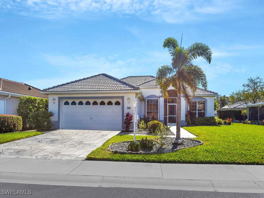 a front view of a house with a yard and garage