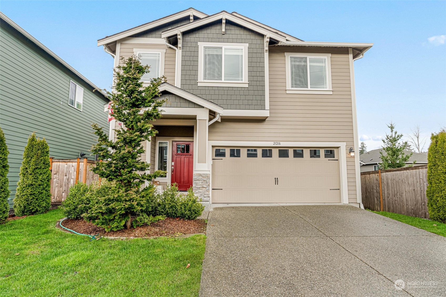 a front view of a house with a yard and garage