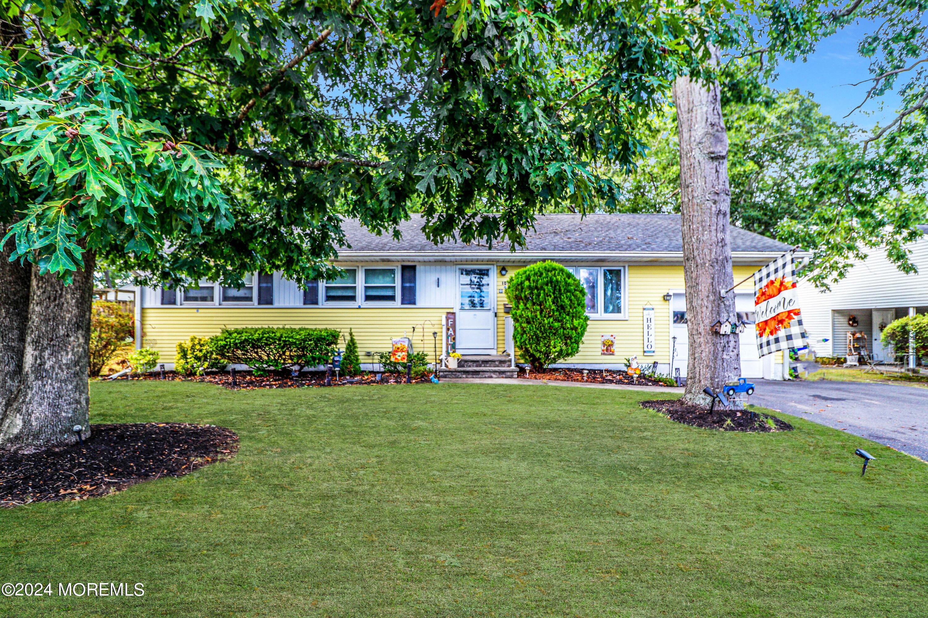 a front view of house with yard and green space