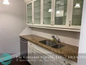 a kitchen with a sink and a mirror