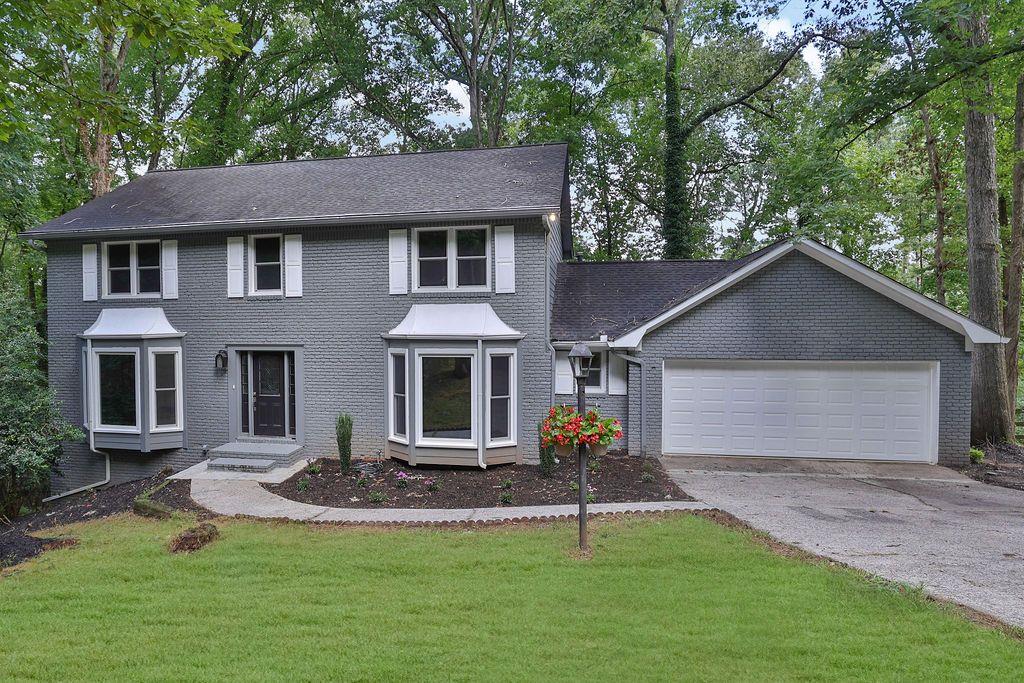 a front view of a house with a yard and garage