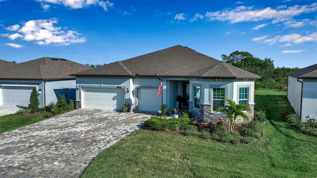 Renown with extra-deep lot, bay window and stone accents