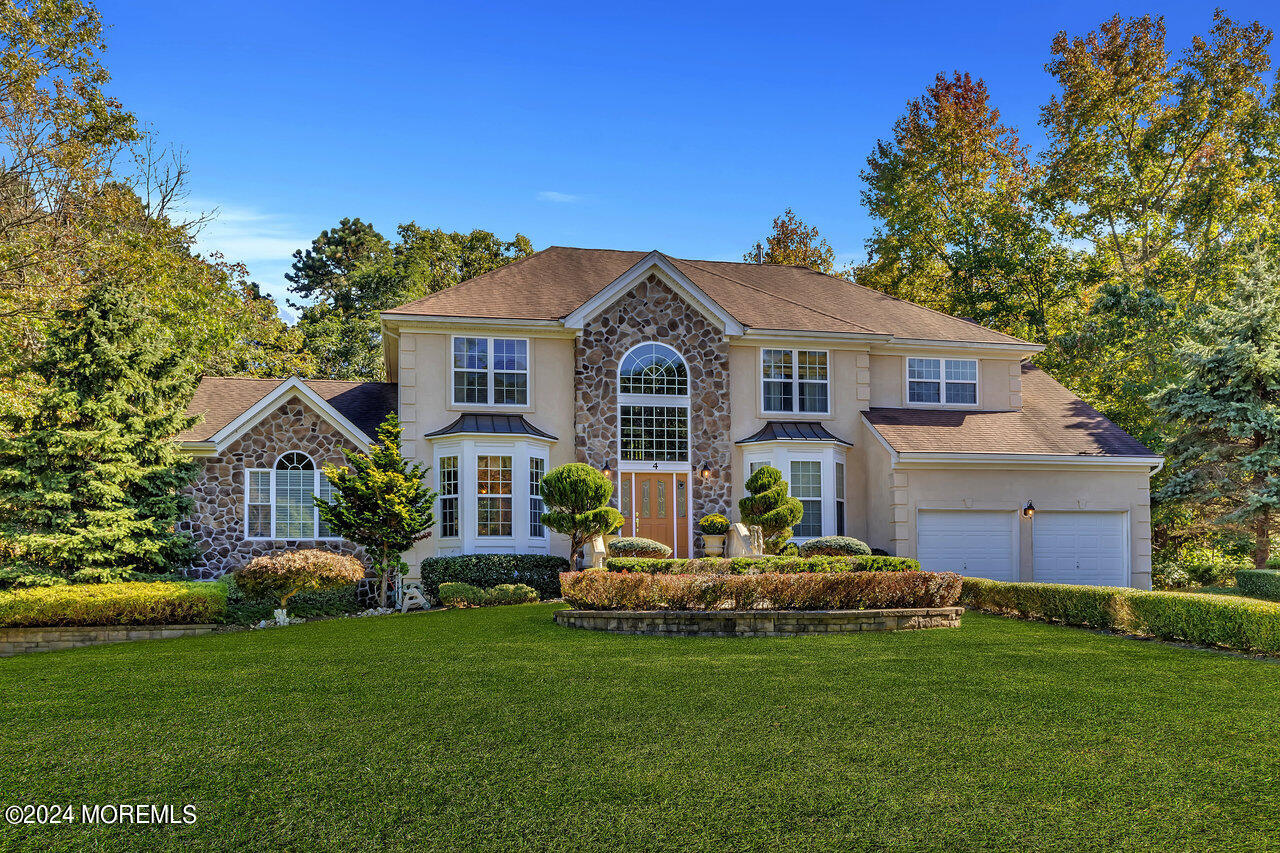 a front view of house with yard and green space