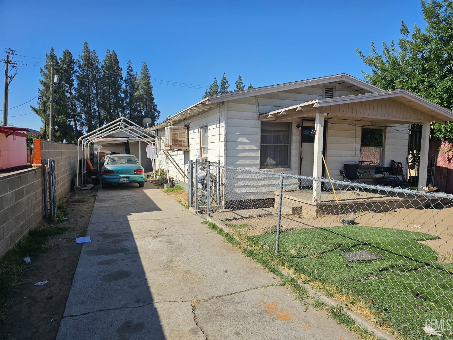 a front view of a house with a yard and potted plants