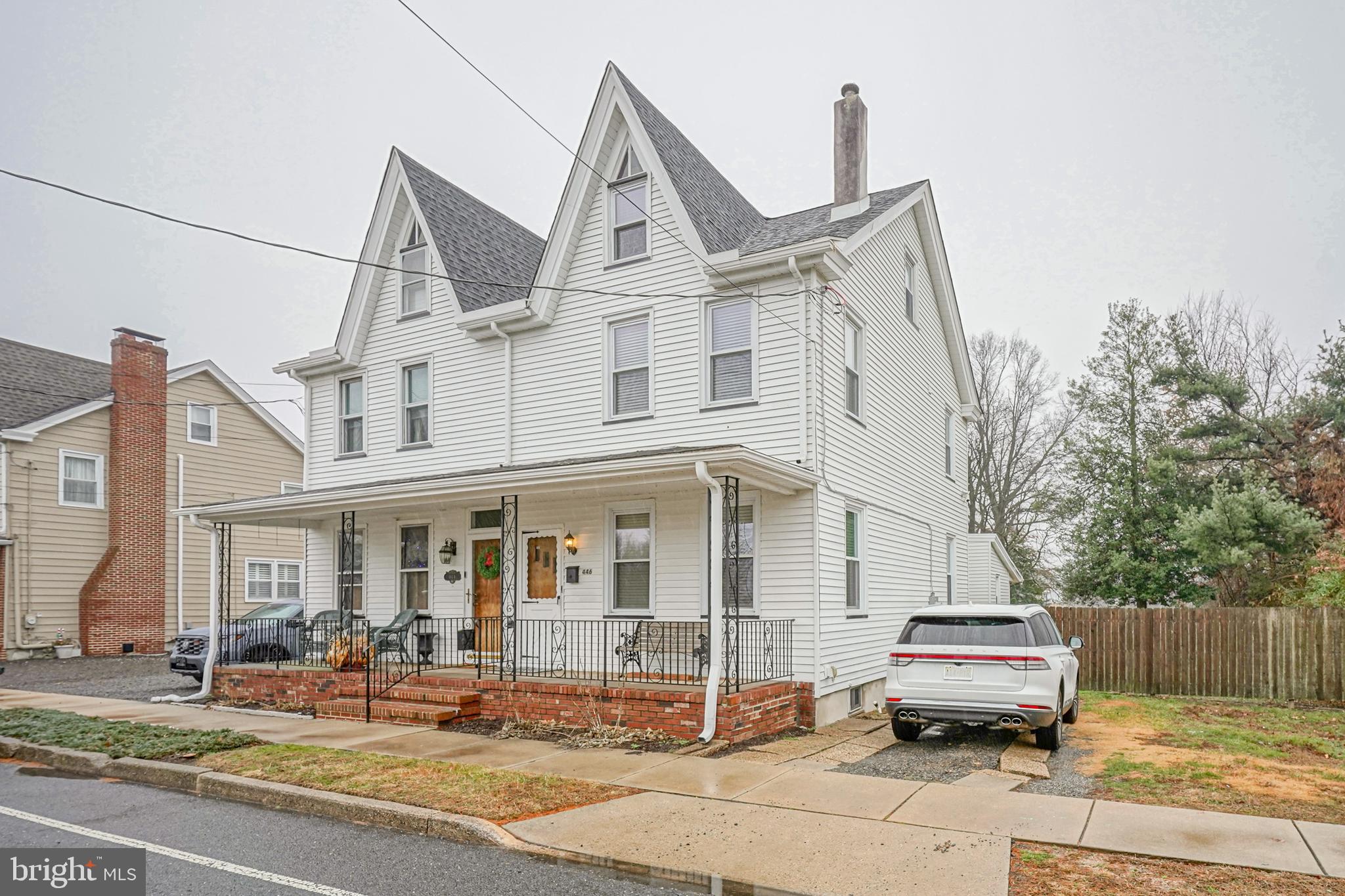 a front view of a house with sitting area