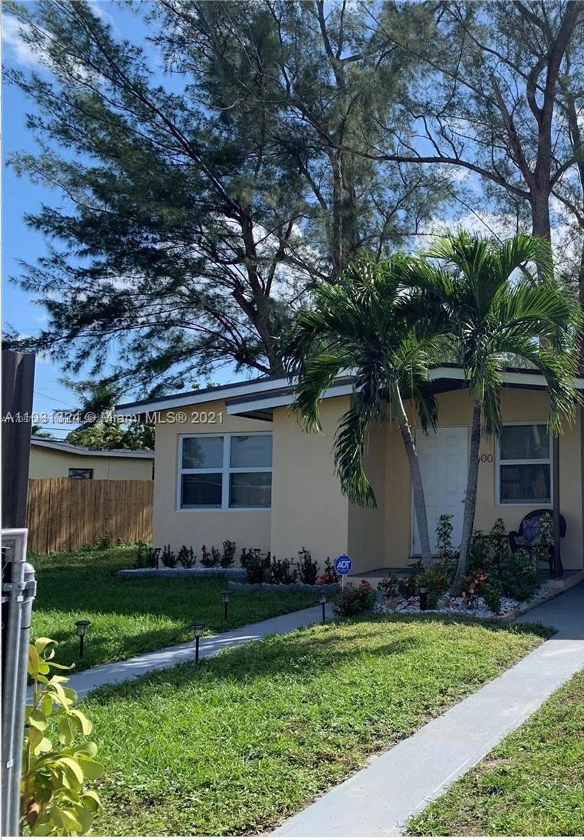 a house that has a tree in front of it