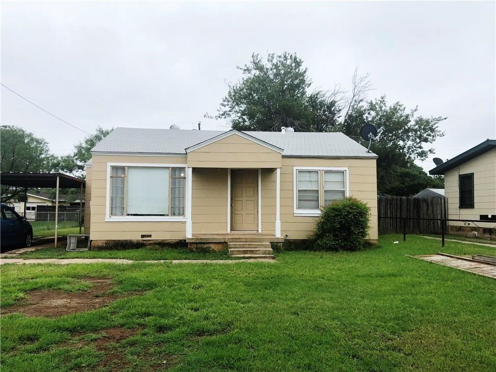 a front view of a house with a garden and yard