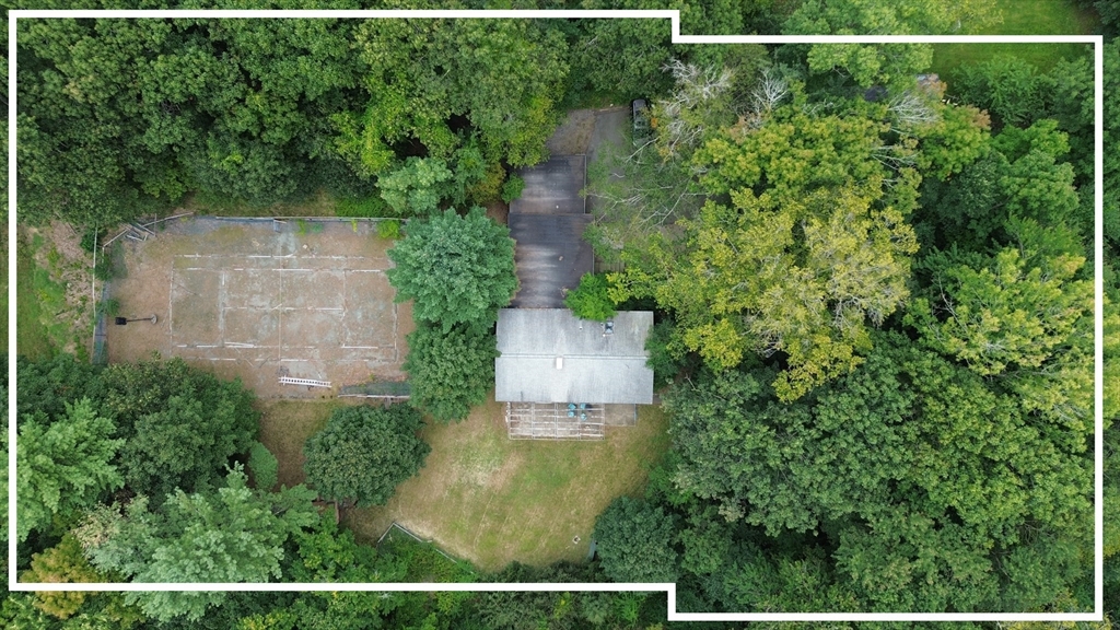 an aerial view of a house with a yard and lake view