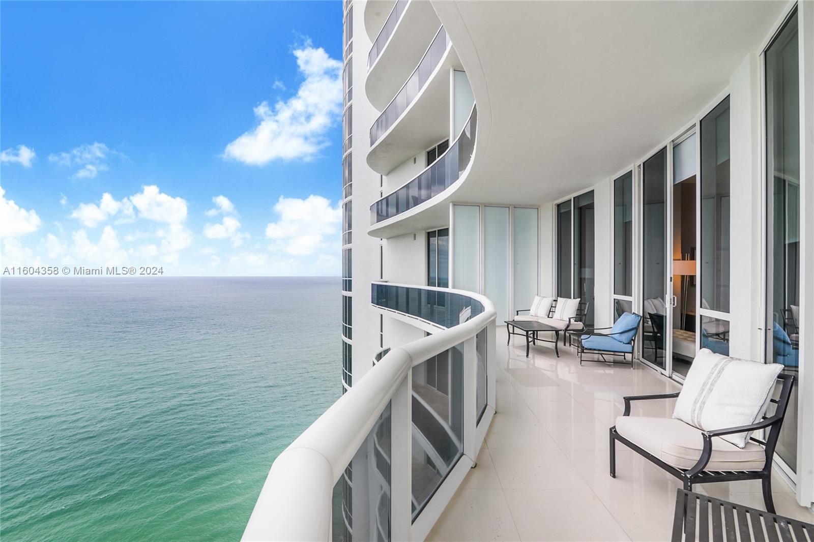 a balcony with chairs and a table