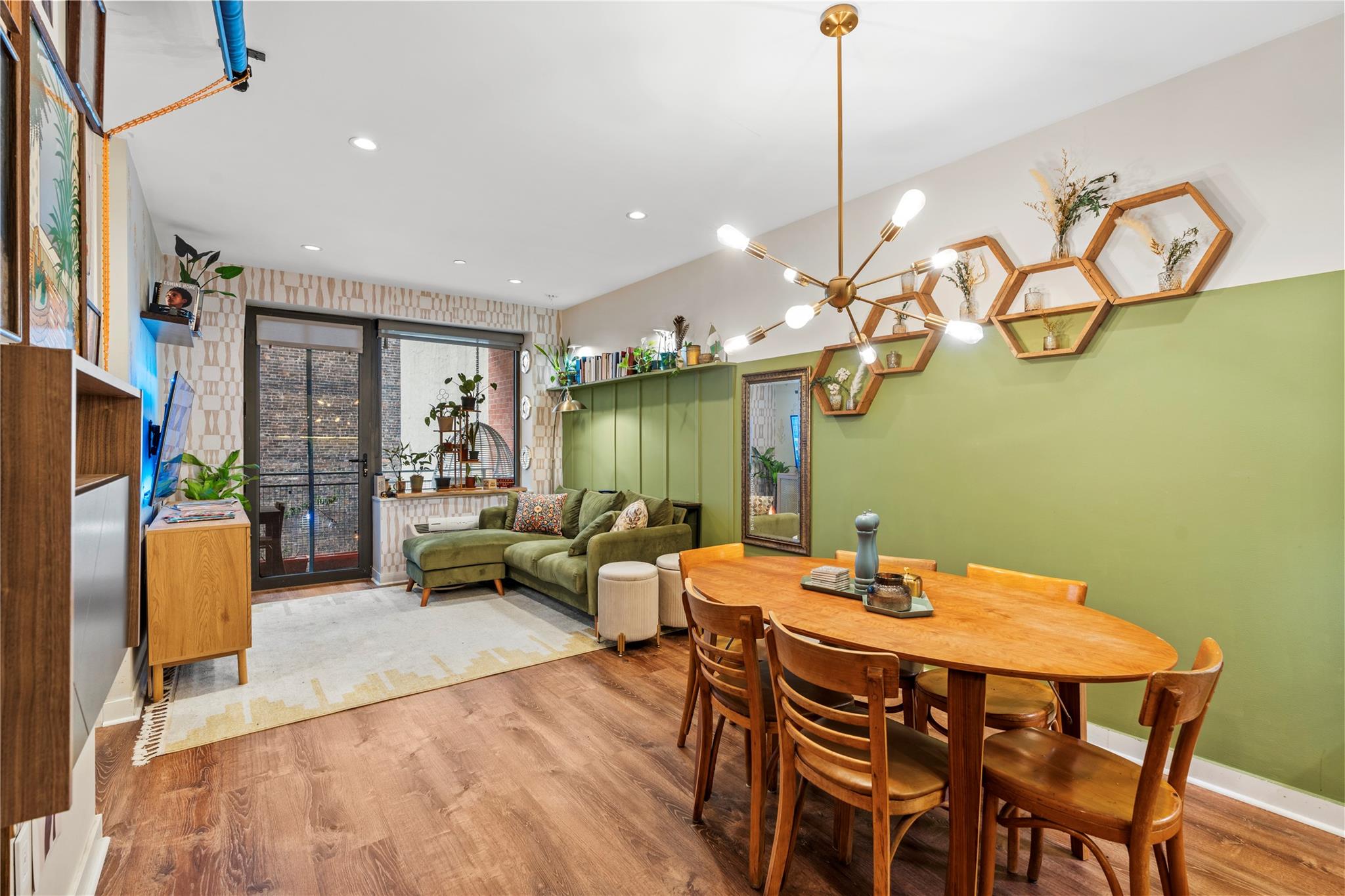 Dining area with light hardwood / wood-style floors and an inviting chandelier