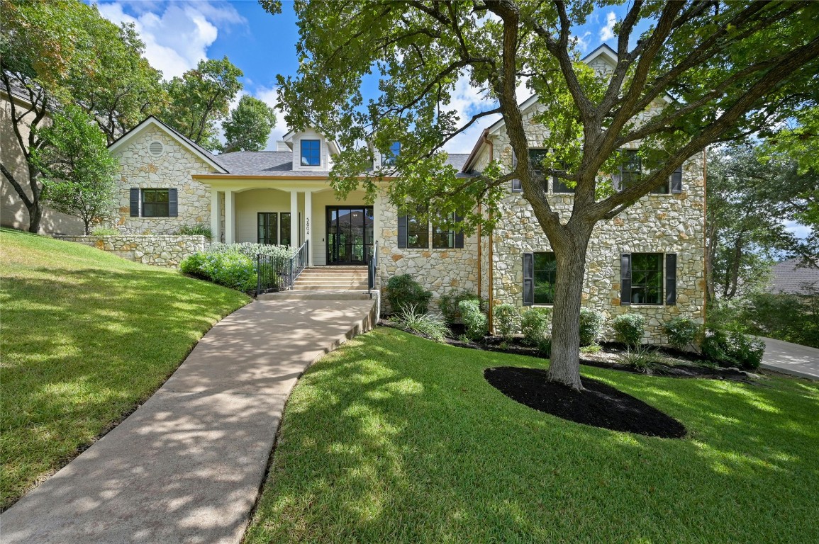 a front view of a house with a garden