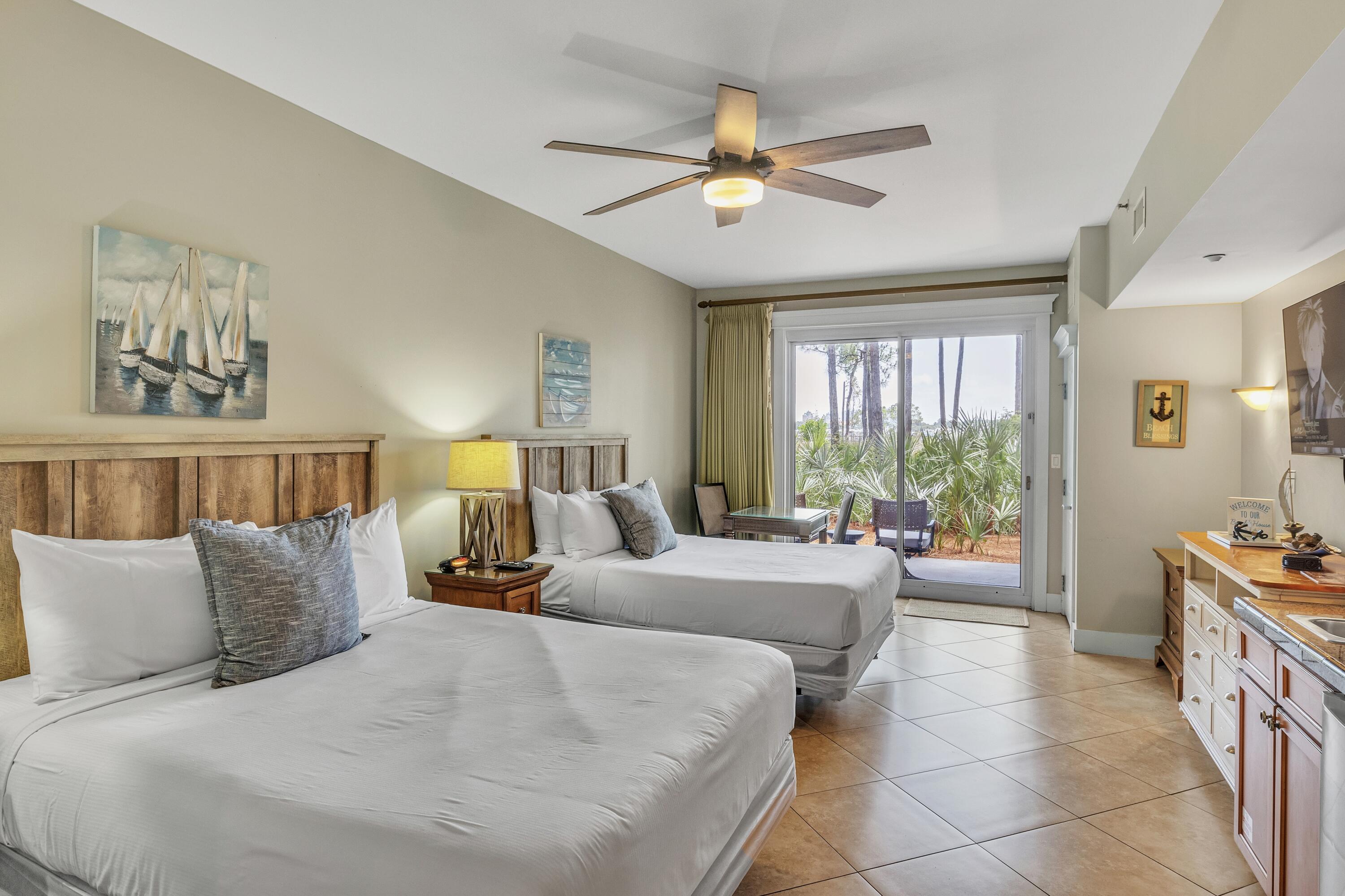 a bedroom with a balcony a bed and a chandelier