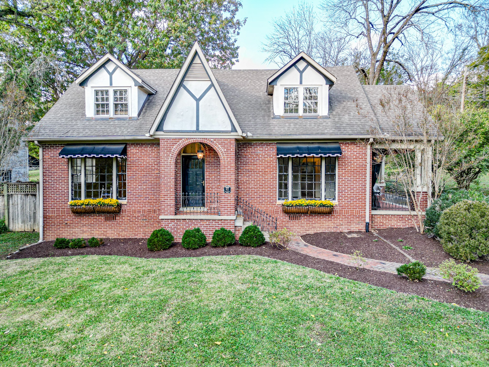 a front view of a house with garden