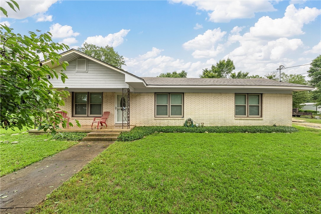 a front view of house with yard and green space