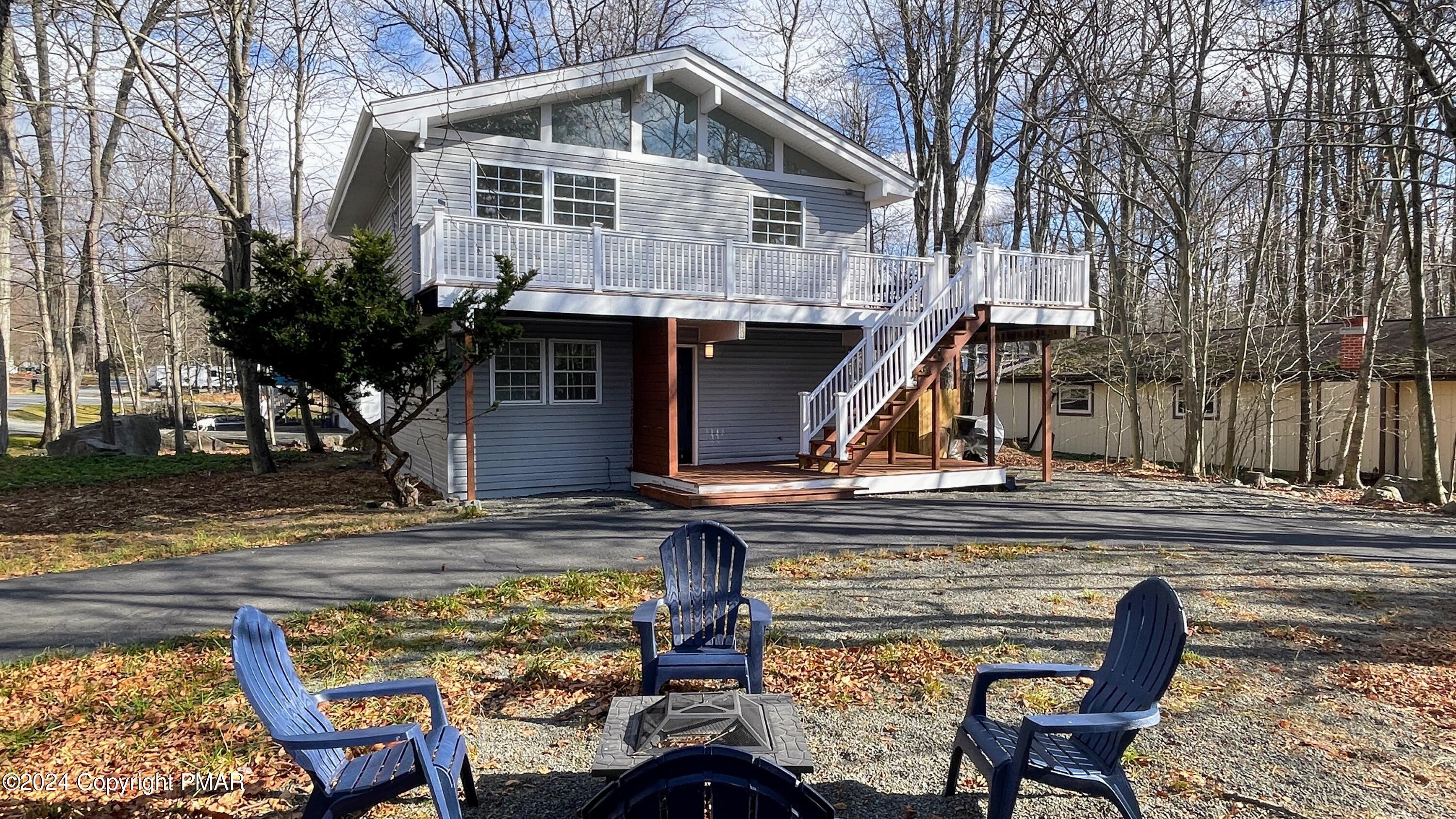 a view of a house with backyard water fountain and sitting area