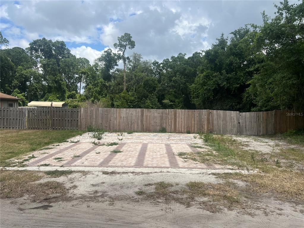 a backyard with wooden fence and a bench