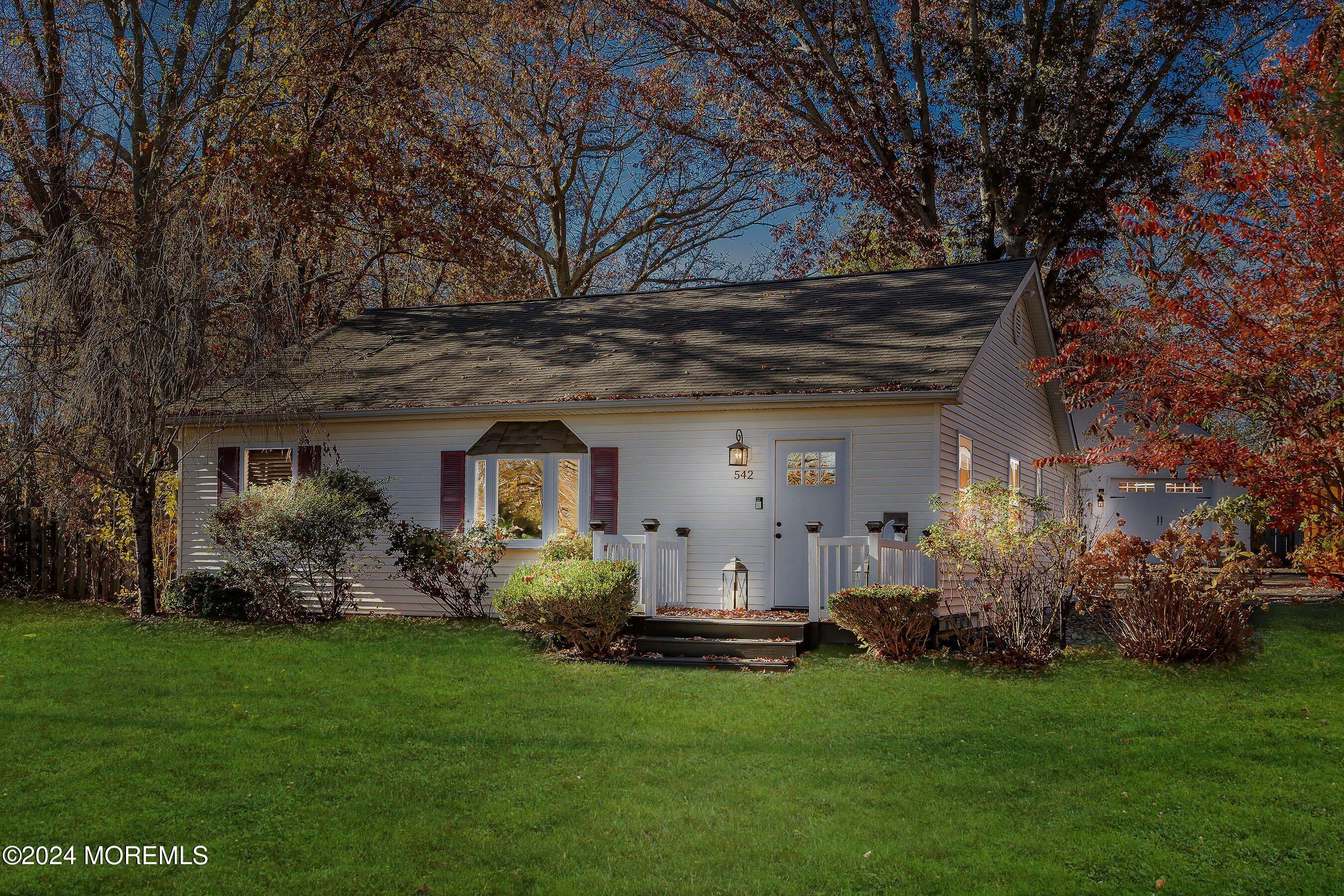 a front view of house with a garden