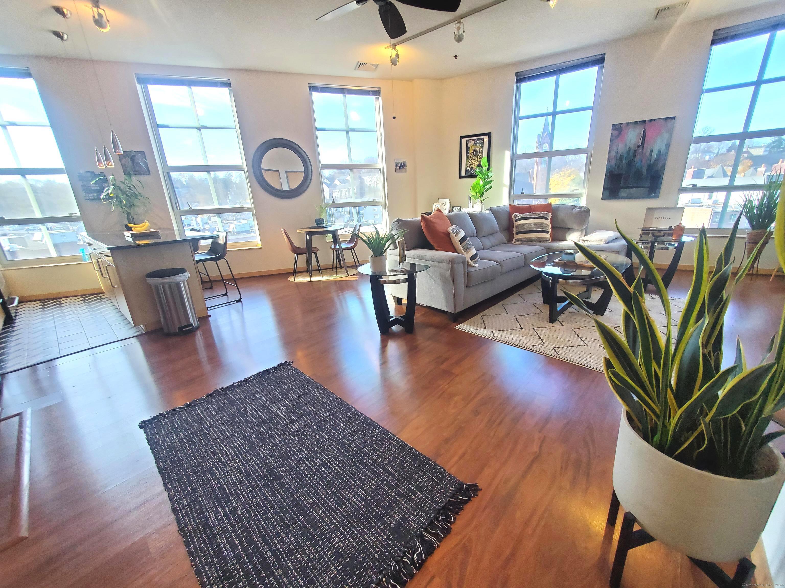 a living room with fireplace furniture and a wooden floor