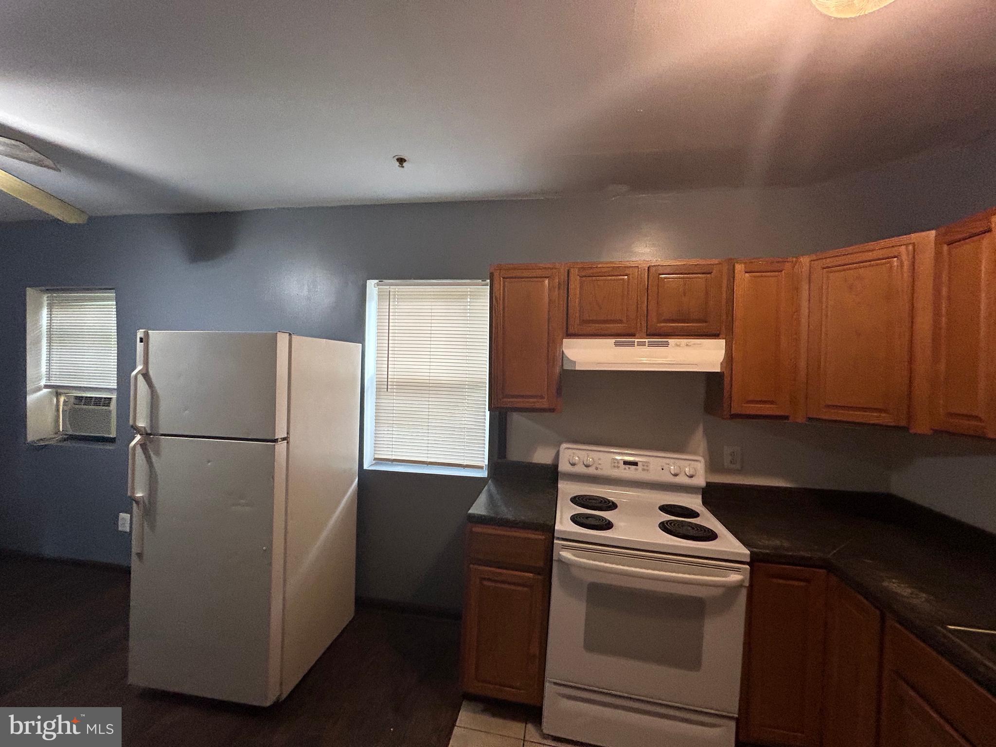 a kitchen with a refrigerator sink stove and cabinets