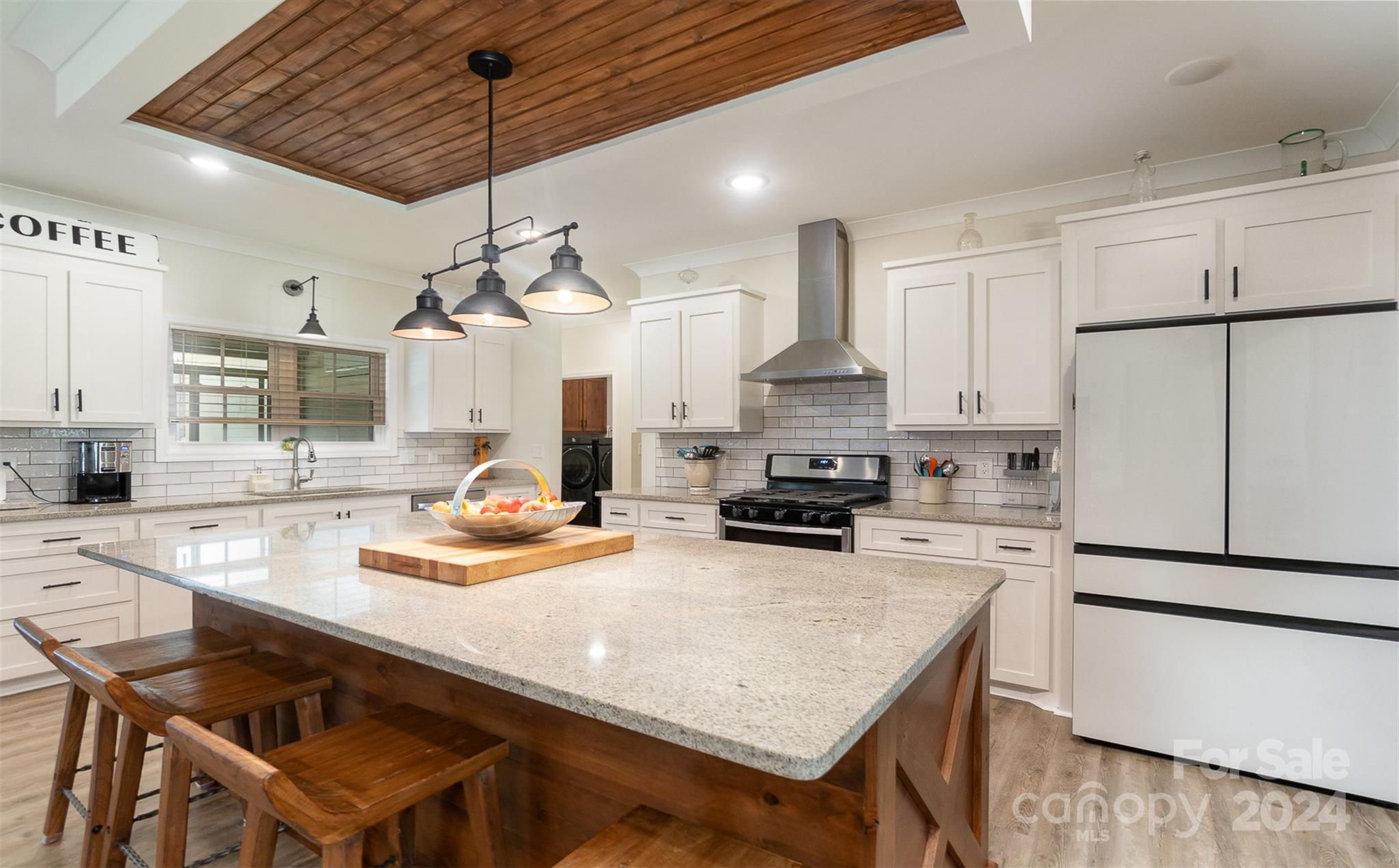 a kitchen with white cabinets and white appliances