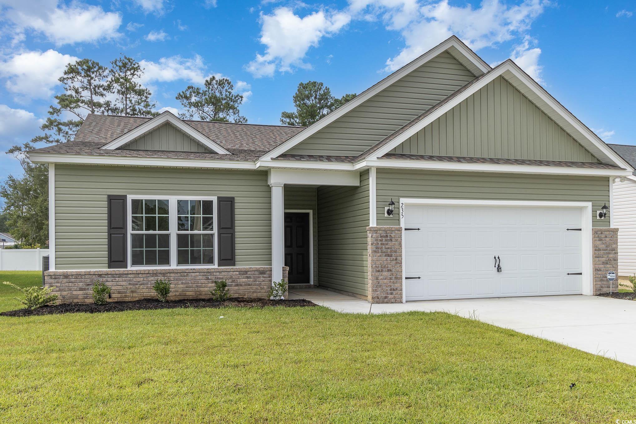 Craftsman-style home with a front yard and a garag