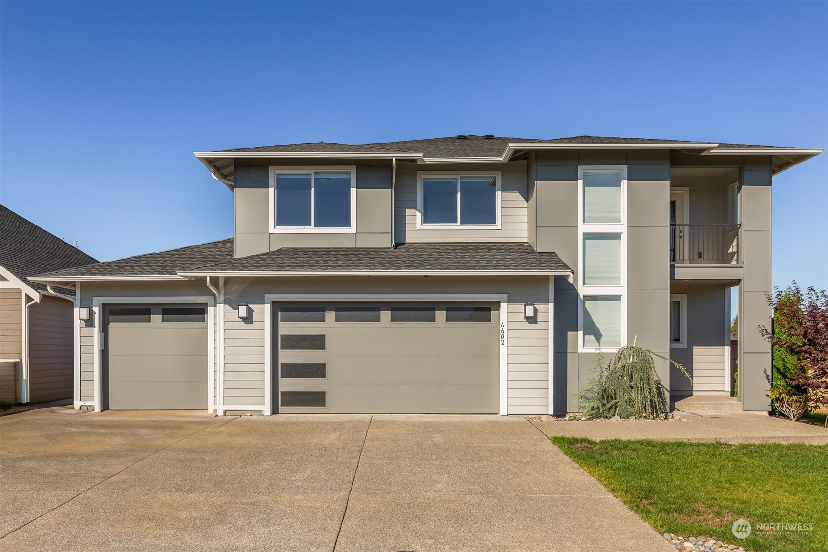 a front view of a house with a yard and garage